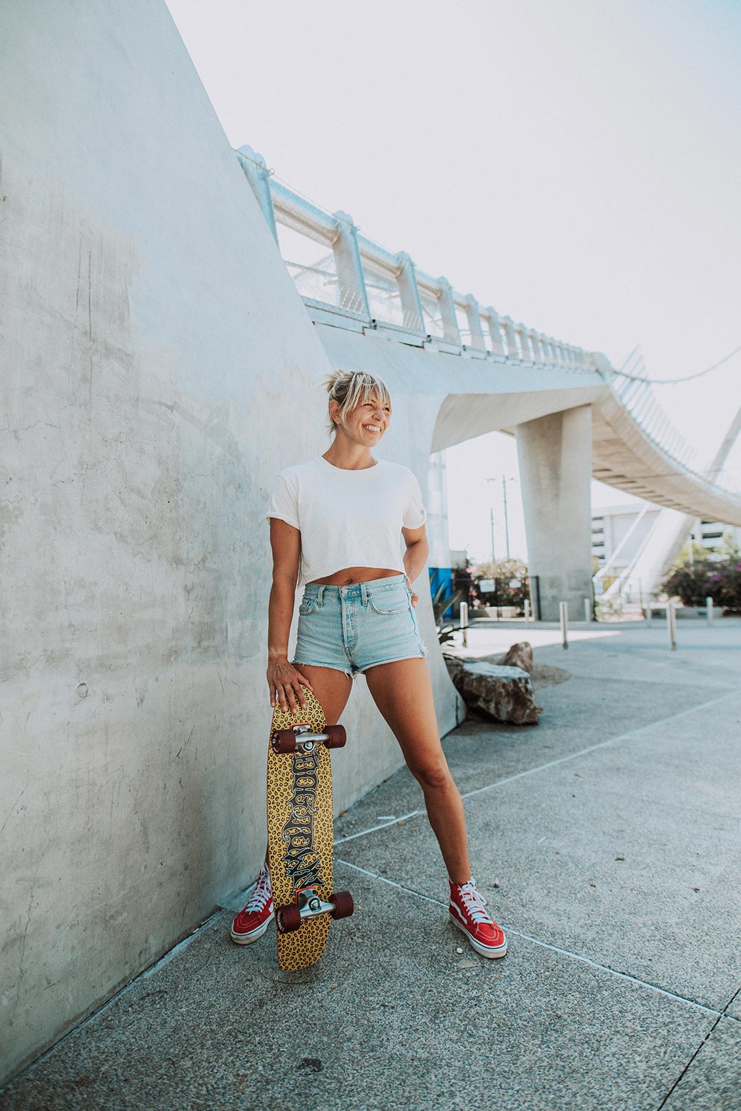 woman standing with skateboard